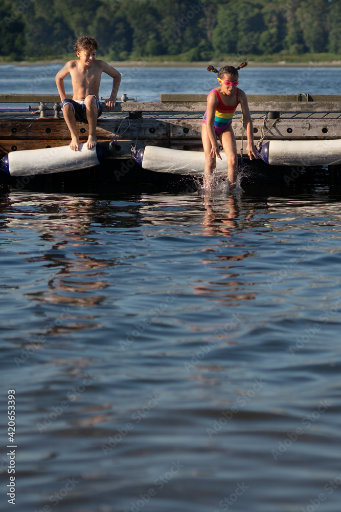 Girl leaps into water, hair flying Girl leaps into water, hair flying
