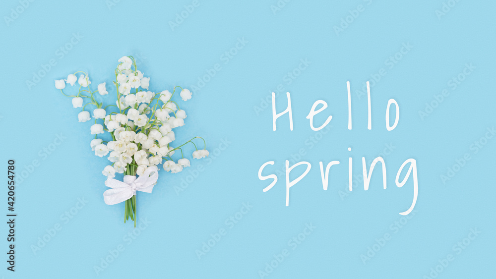 Delicate spring flowers blooming white lily of the valley on blue. Spring floral conceptual image.
