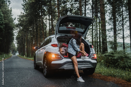 Woman tying her shoes in the car