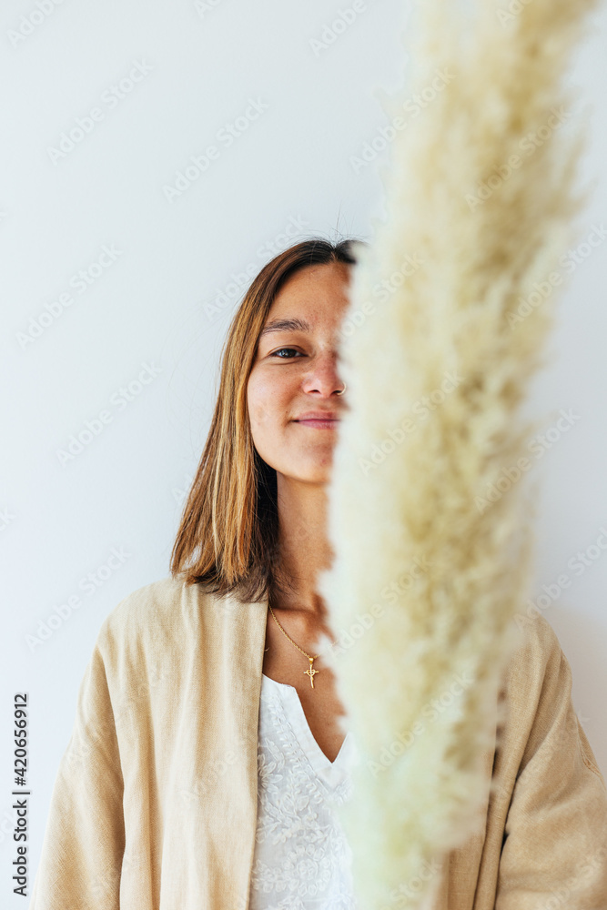 Portrait of female holding pampas grass Portrait of female holding pampas grass