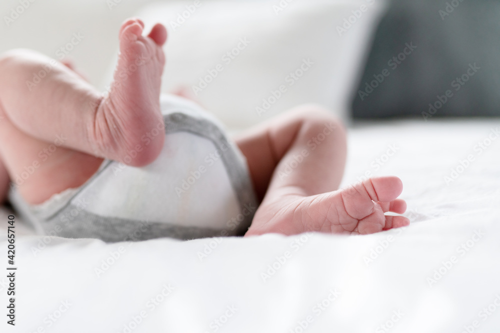 Newborn feet on white bed Newborn feet on white bed