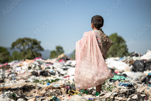 Poor children collect garbage for sale because of poverty, Junk recycle, Child labor, Poverty concept, human trafficking, World Environment Day, photo