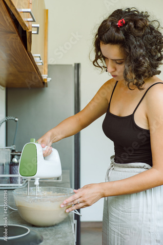 Girl uses an electronic mixer