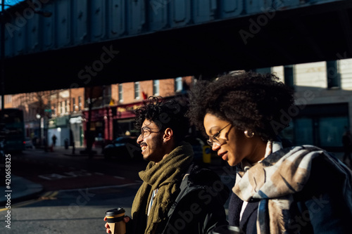 Young Black Couple Walking Downtown photo