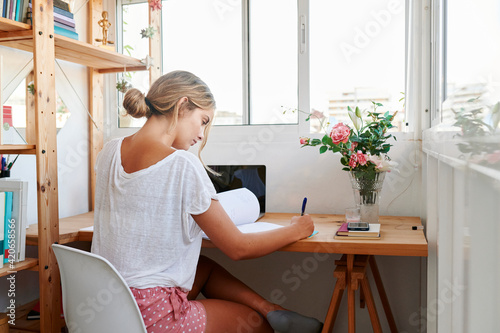 Young woman studying in her dorm room