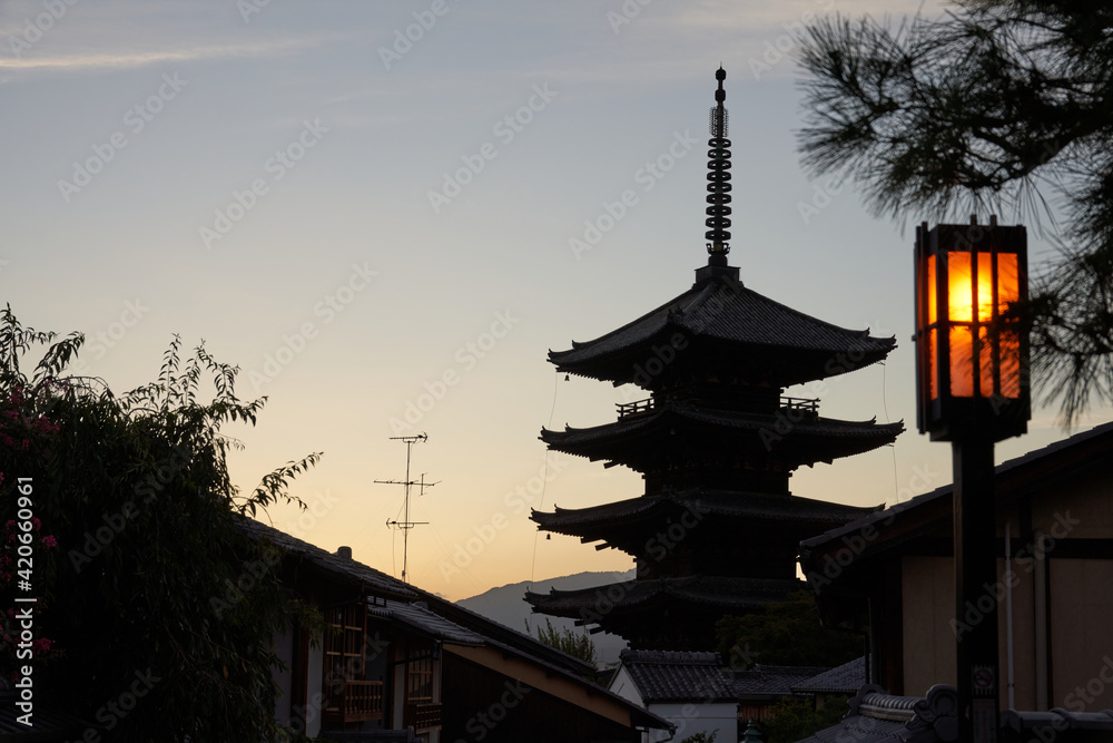 Traditional oriental pagoda in garden against sunset sky Traditional oriental pagoda in garden against sunset sky