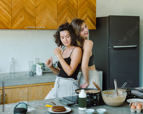 Girls prepare food and dancing in the kitchen