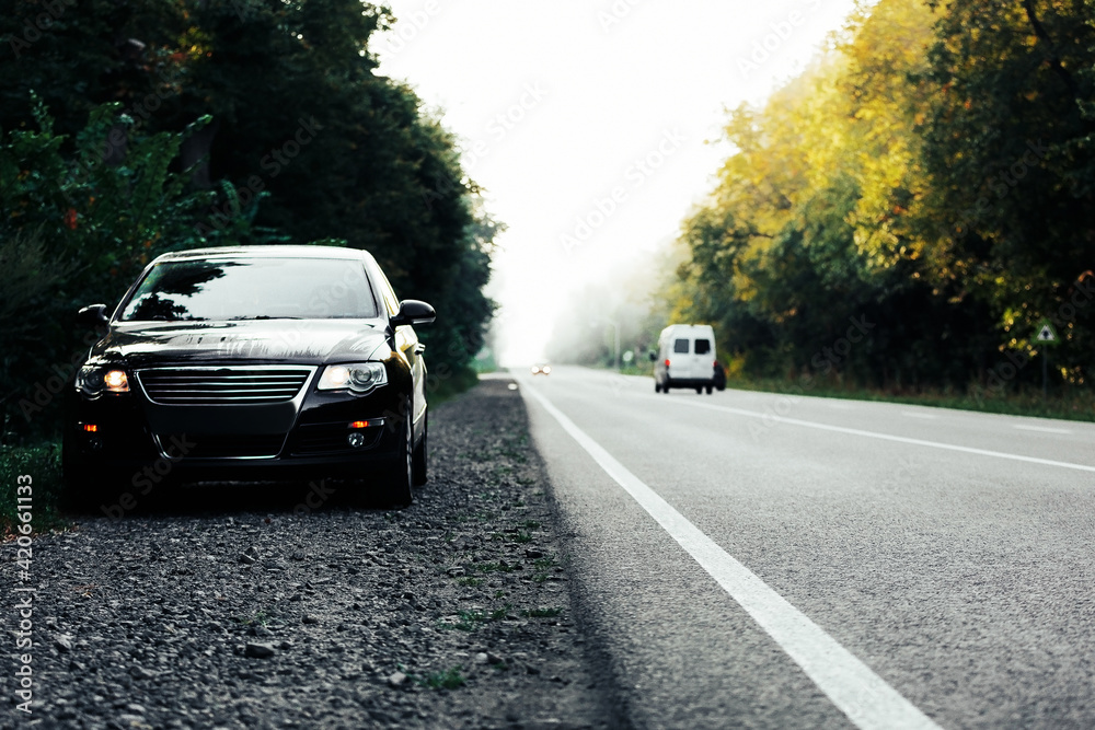black car on asphalt road black car on asphalt road