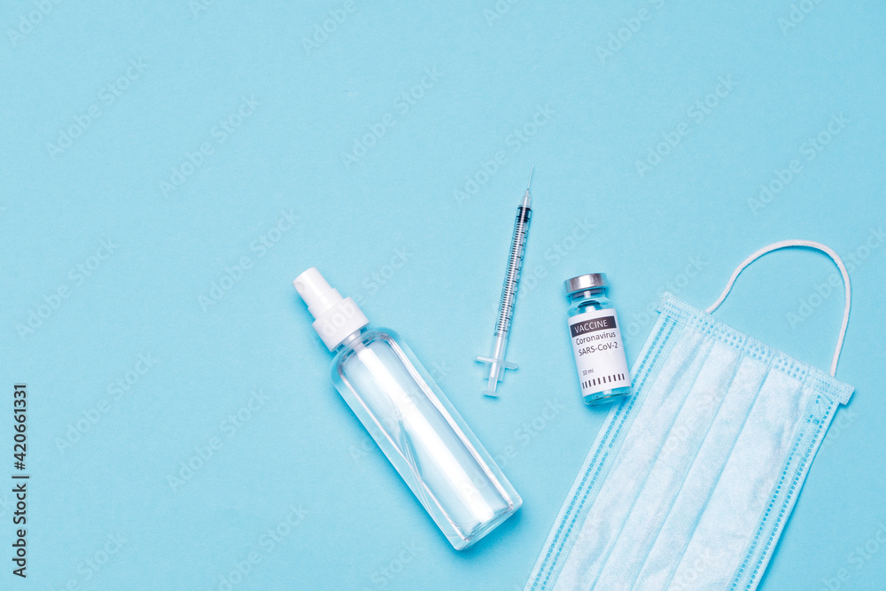 Vaccine bottles, vials medicine and syringe injection isolated on blue. Coronavirus 2019-ncov. Vaccine bottles, vials medicine and syringe injection isolated on blue. Coronavirus 2019-ncov.