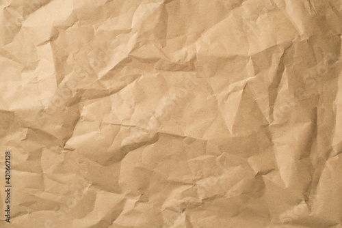 Top view photo of isolated beige crumpled craft paper background with copyspace