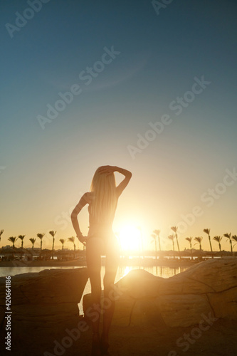 silhouette of woman at sunset seaside beach