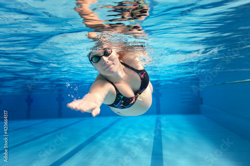 Pregnant woman swimming photo