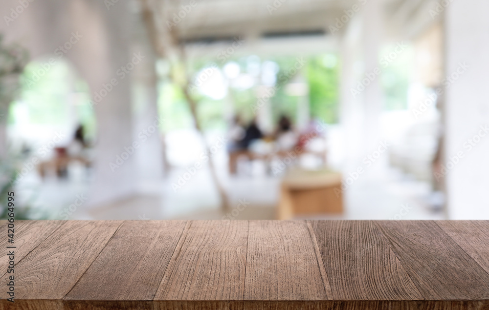 Empty wooden table in front of abstract blurred background of coffee shop . can be used for display or montage your products.Mock up for display of product Empty wooden table in front of abstract blurred background of coffee shop . can be used for display or montage your products.Mock up for display of product