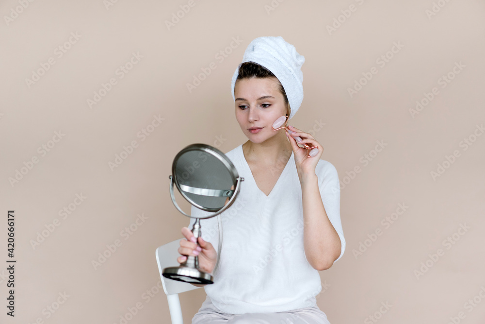 Woman doing facial massage with stone in bathroom Woman doing facial massage with stone in bathroom