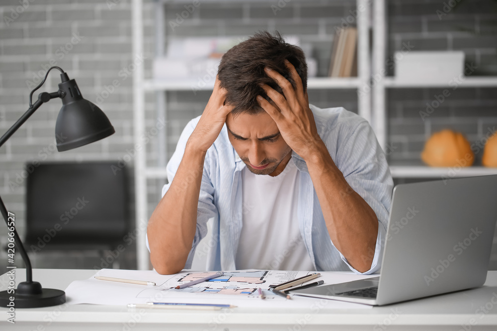 Portrait of stressed young man in office Portrait of stressed young man in office