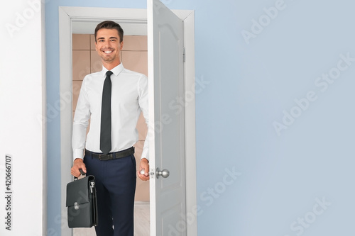 Successful businessman standing in doorway