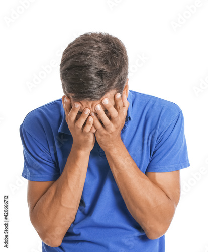 Portrait of stressed young man on white background