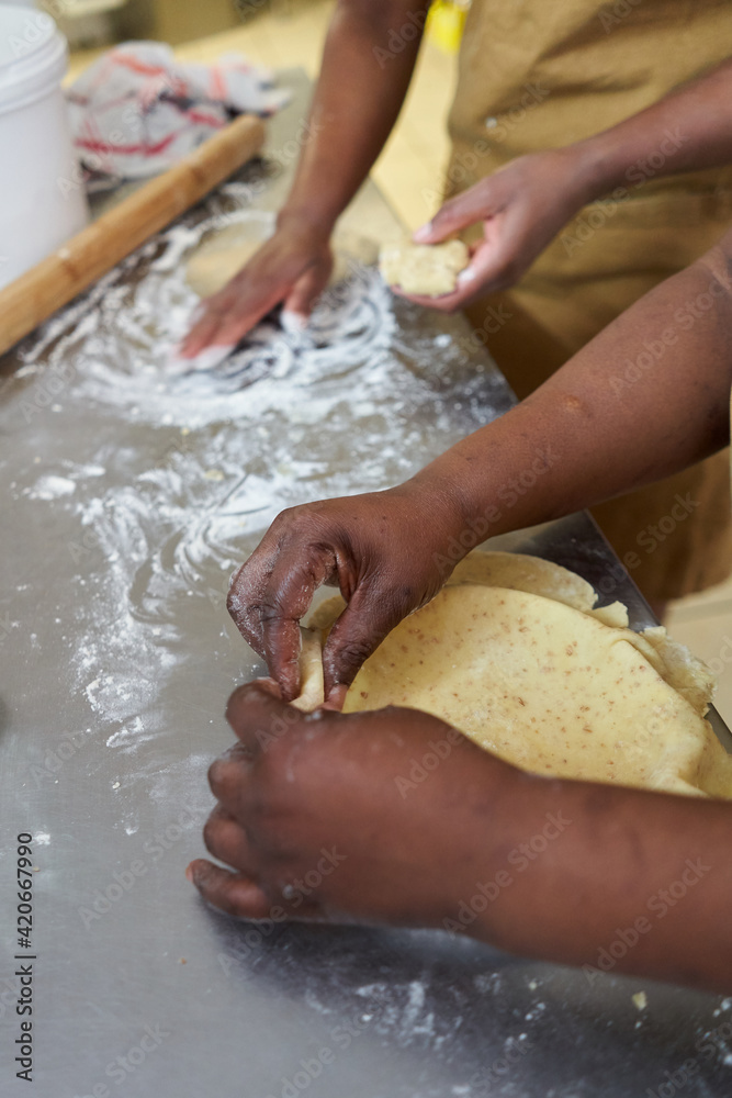 Cooks hands making pies for a food delivery business Cooks hands making pies for a food delivery business