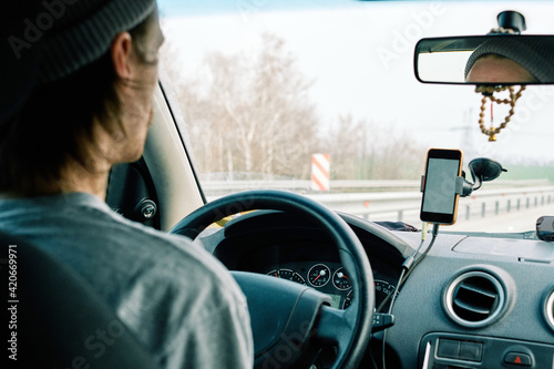 A young man traveling by car photo