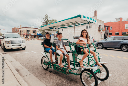 Family riding around St. Joe Michigan in a surrey bike.