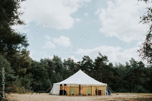 White round tent in the middle of a forest photo