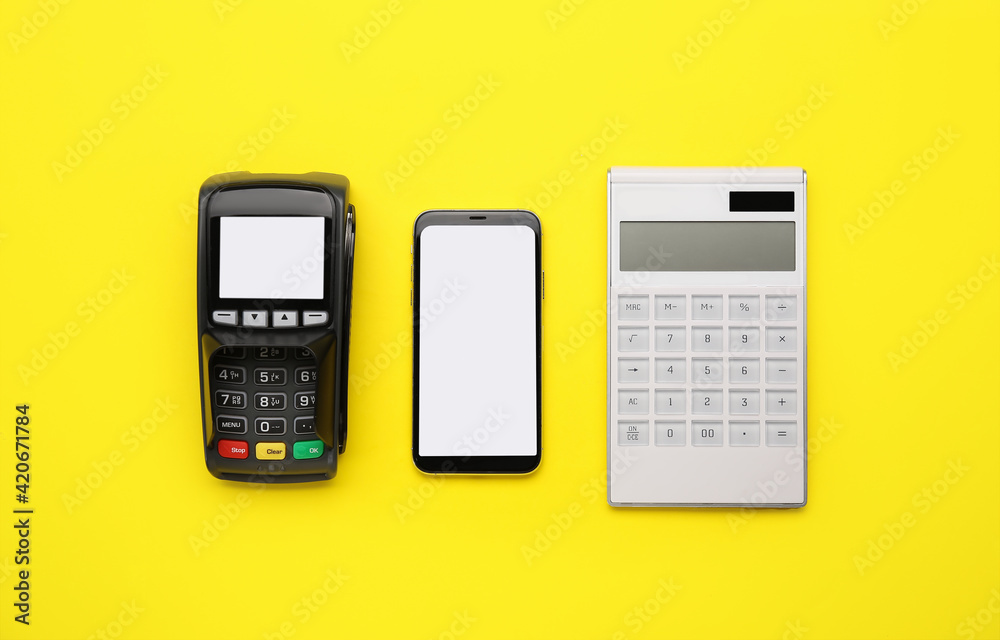 Calculator with payment terminal and mobile phone on color background Calculator with payment terminal and mobile phone on color background
