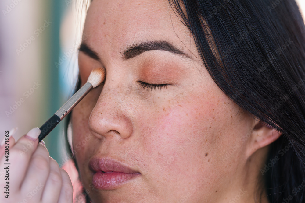 model having make up applied to her face model having make up applied to her face
