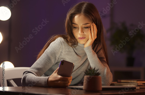 Young woman with mobile pho...