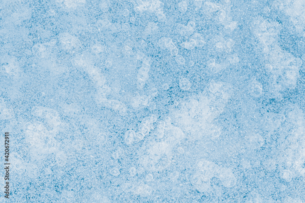 Obraz premium Blue tone, textured ice surface with air bubbles inside.