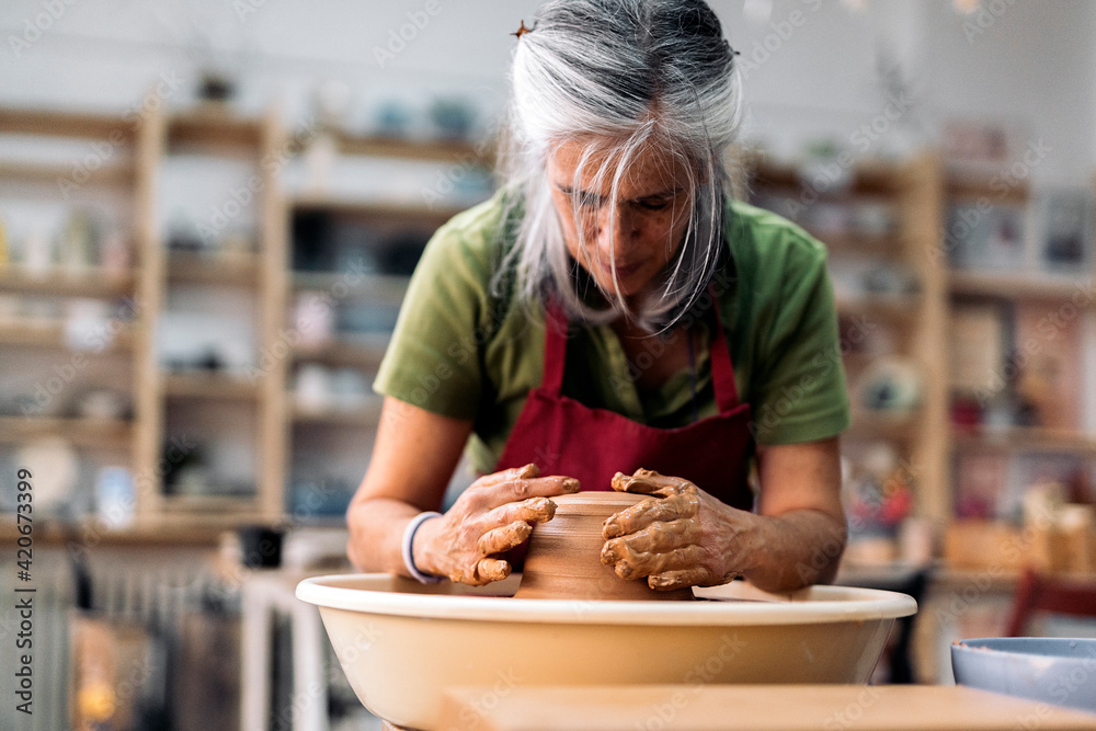 © Nunez Image/Stocksy - Woman Making Pottery On Spinning Wheel © Nunez Image/Stocksy - Woman Making Pottery On Spinning Wheel