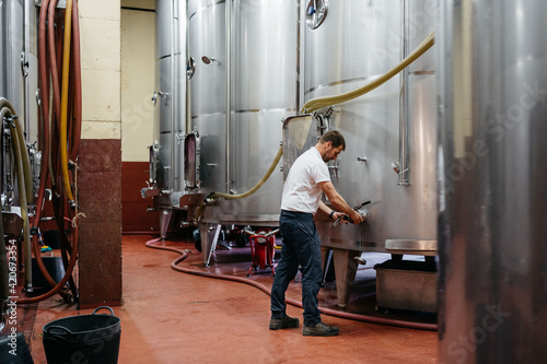 Farmer checking machinery in the winery