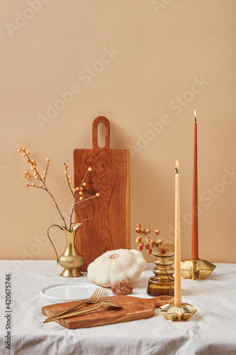 Creative composition from cutlery, boards and candles.