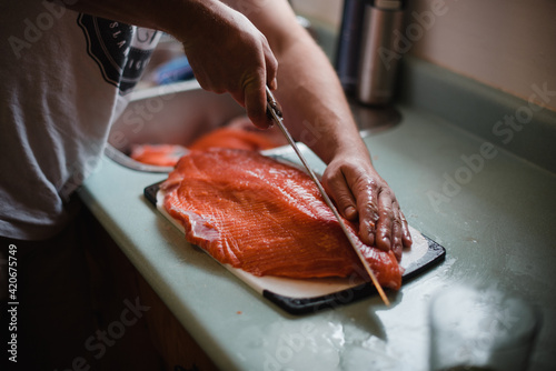 Man filleting fresh caught salmon photo