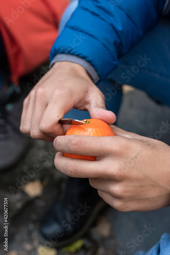 Young man Peeling A Mandarin photo
