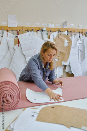 business woman fashion designer at her in her clothing manufacturing office