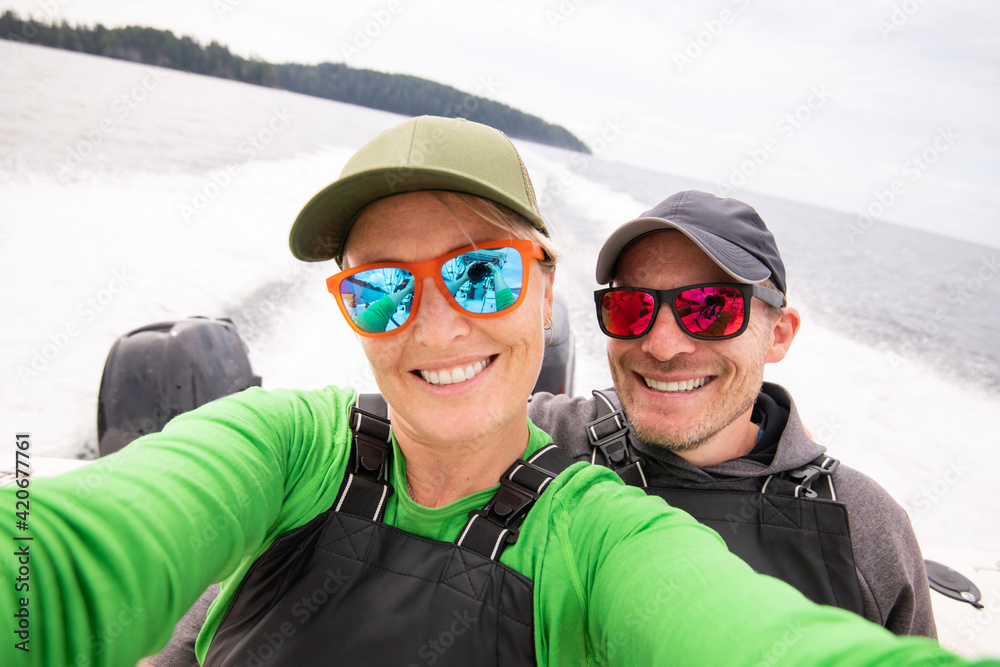 Smiling couple taking a selfie on a fishing boat Smiling couple taking a selfie on a fishing boat