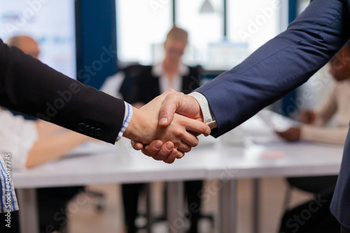 Satisfied businessman company employer wearing suit handshake new employee get hired at job interview, Man hr manager employ successful candidate shake hand at business meeting, placement concept photo
