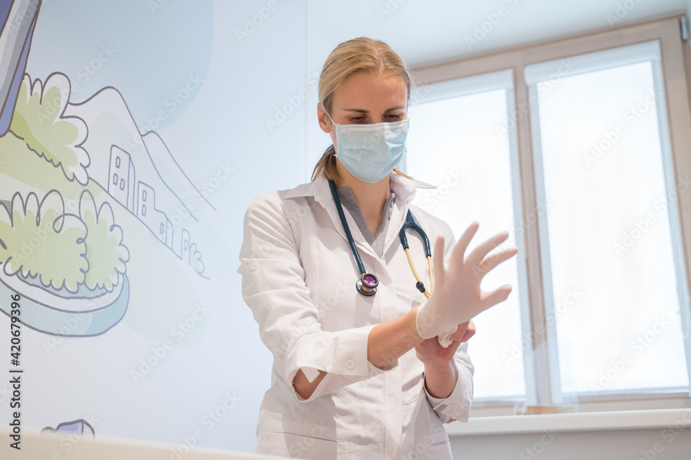 Medical Worker Putting On Disposable Gloves Medical Worker Putting On Disposable Gloves