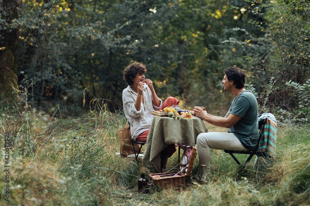 A Man and a Woman Having Lunch in Nature A Man and a Woman Having Lunch in Nature
