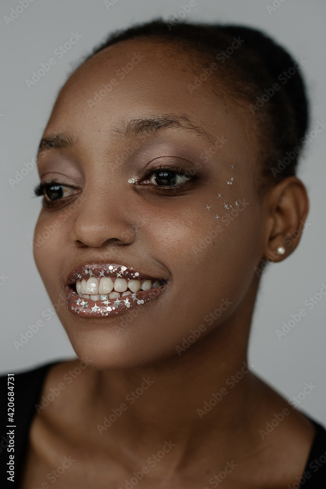 Portrait of young African girl with glitter on her face Portrait of young African girl with glitter on her face