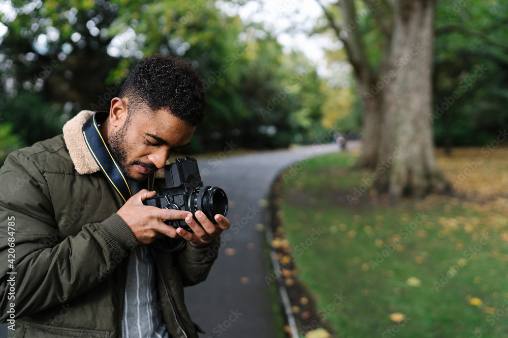 Young Man Using an Anologe Camera Young Man Using an Anologe Camera