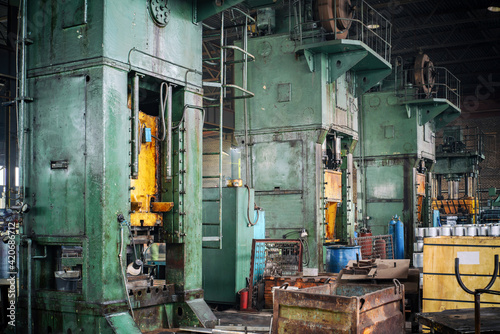 industrial pressing machines in factory interior, blurred background