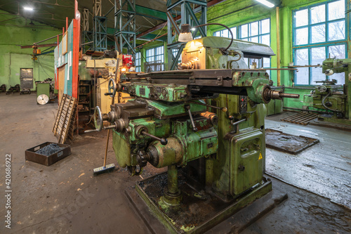 lathe in factory interior, blurred background