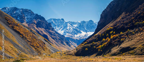 North Ossetia, Russia, Kurtatinsky gorge. View through the gorge to the snow-capped mountains photo