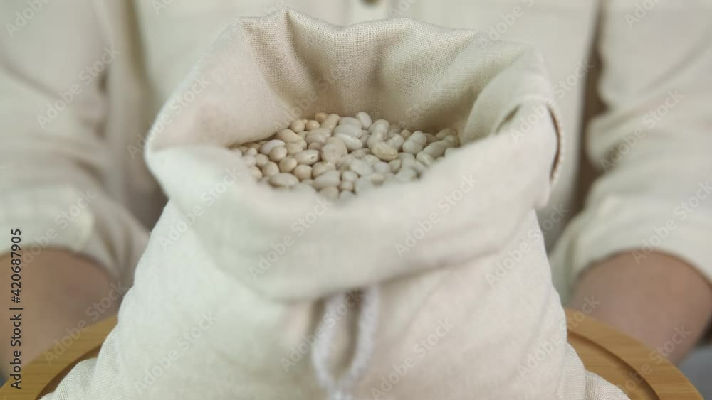 Organic haricot. Woman with eco-friendly bean bag.