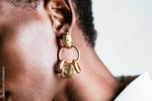 Crop black woman in golden earrings photo