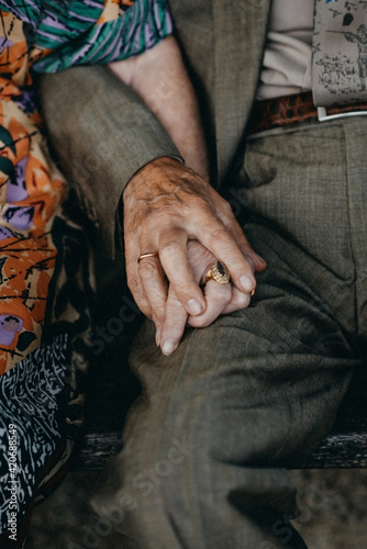 Older aged woman and man holding hands photo