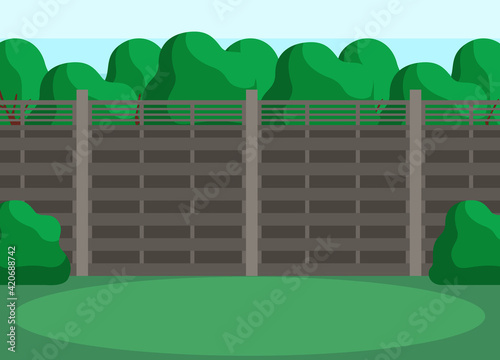 Trees, grass and bushes as elements of interior landscape. Back yard with green lawn behind fence