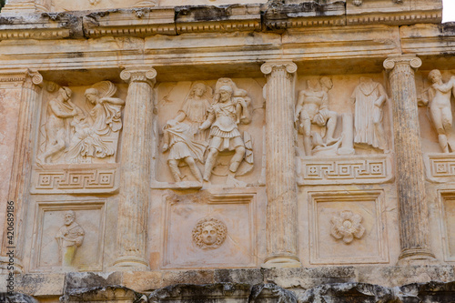 Closeup of figured marble reliefs of antique temple Sebasteion with mythological, allegorical and imperial subjects in ancient city of Aphrodisias, Turkey photo