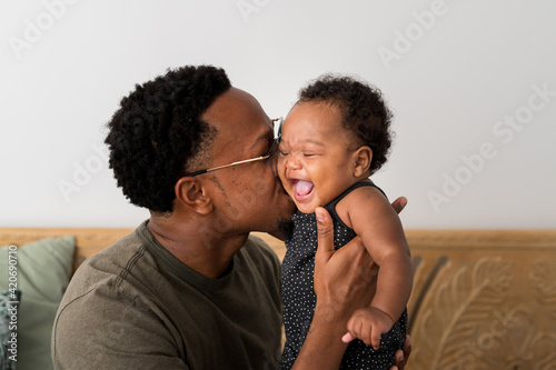 Dad smooching his daughter photo